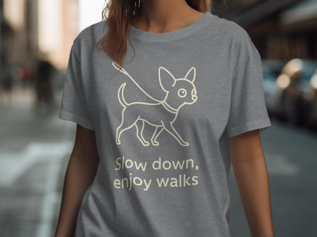 Gray t-shirt with line drawing of a dog and text "Slow down, enjoy walks."