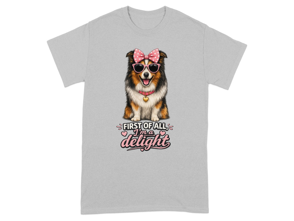 A dog wearing sunglasses and a bow on a t-shirt saying "First of all I'm a delight".
