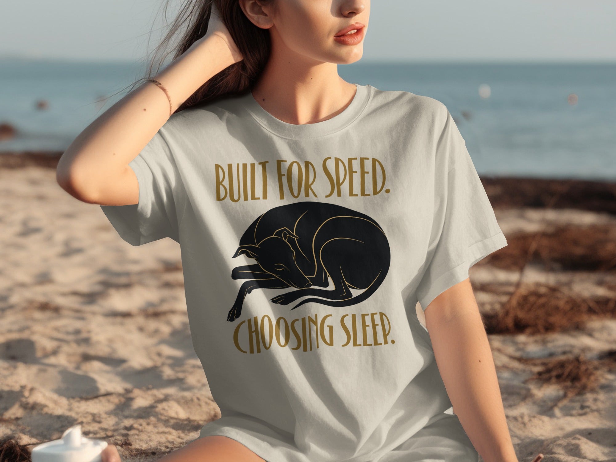 Woman wearing a t-shirt with a sleeping dog graphic and text.