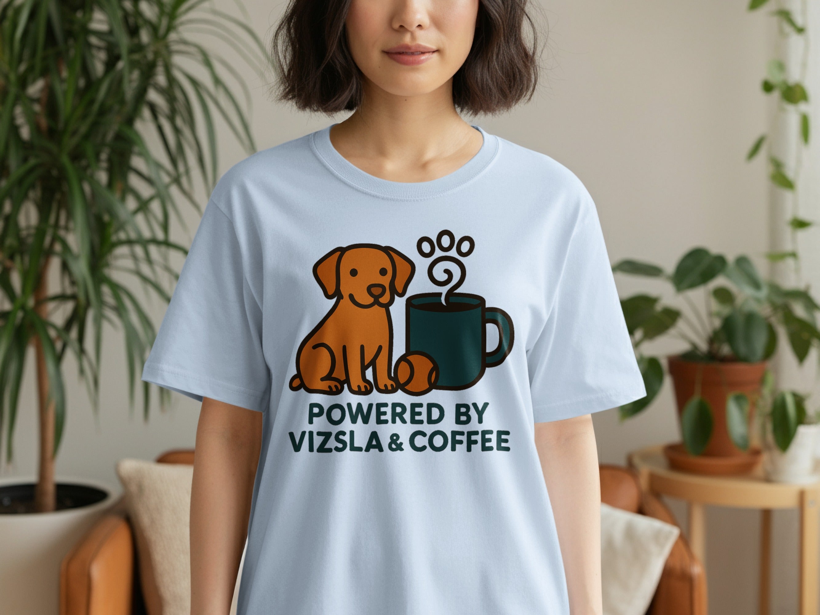 Light blue t-shirt with cartoon vizsla, coffee mug, and paw print. "Powered by Vizsla & Coffee" text.