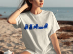 White t-shirt with a blue graphic of pugs in various poses on a beach.