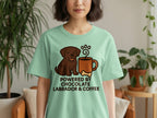 Brown labrador graphic on a mint green t-shirt reads "Powered By Chocolate Labrador & Coffee".