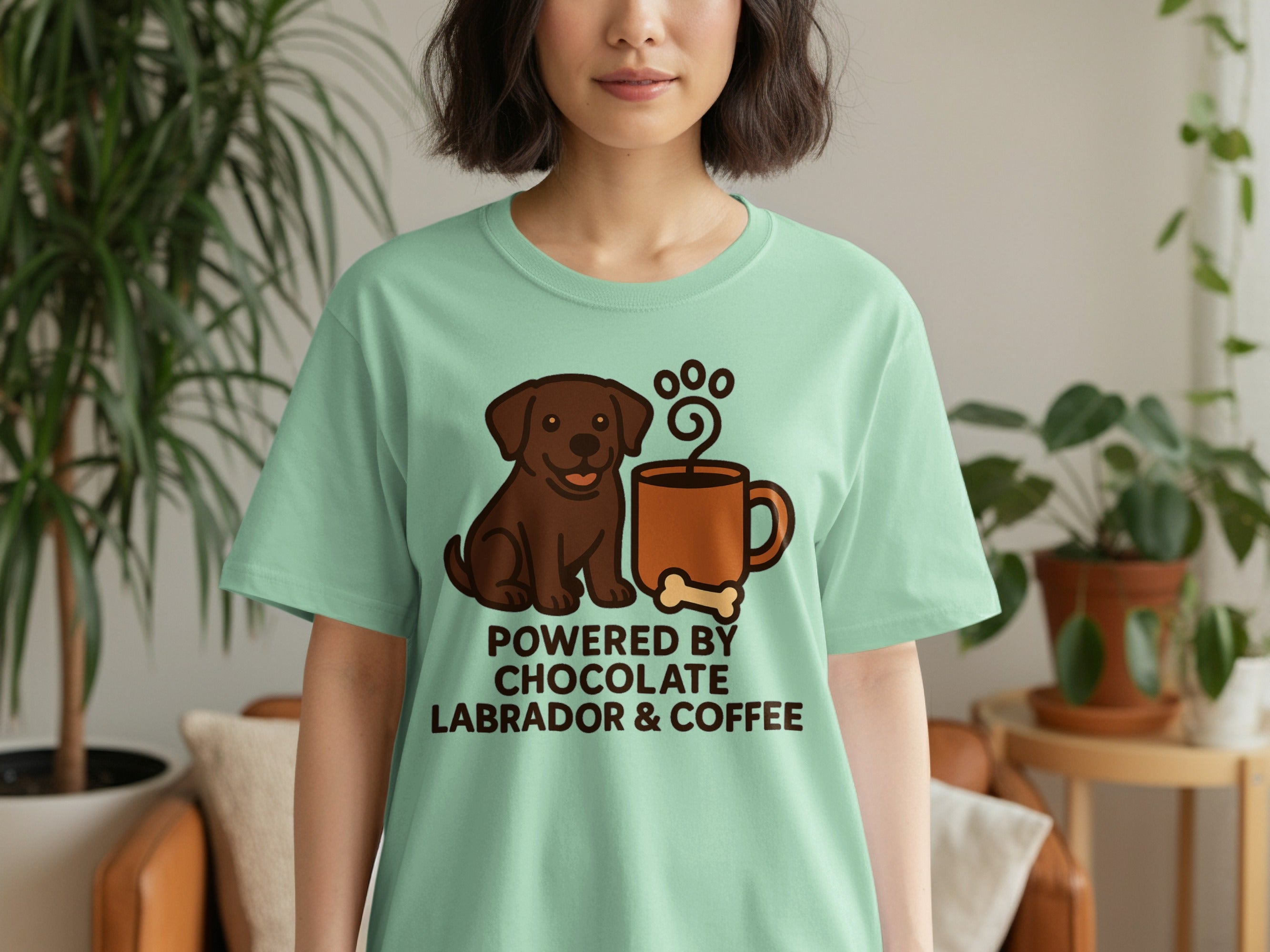 Brown labrador graphic on a mint green t-shirt reads "Powered By Chocolate Labrador & Coffee".