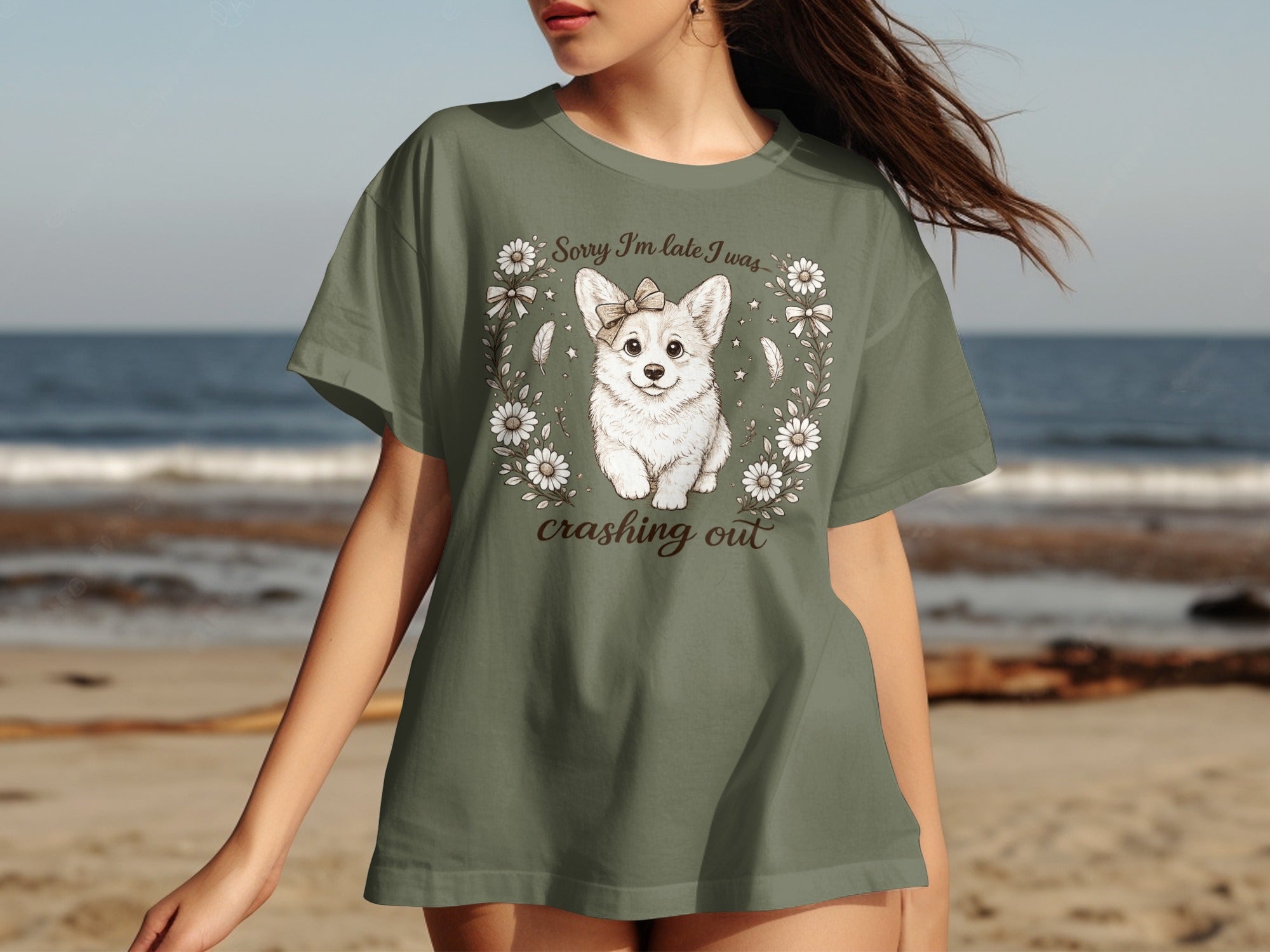 Green t-shirt featuring a corgi wearing a bow with text "Sorry I'm late I was crashing out".