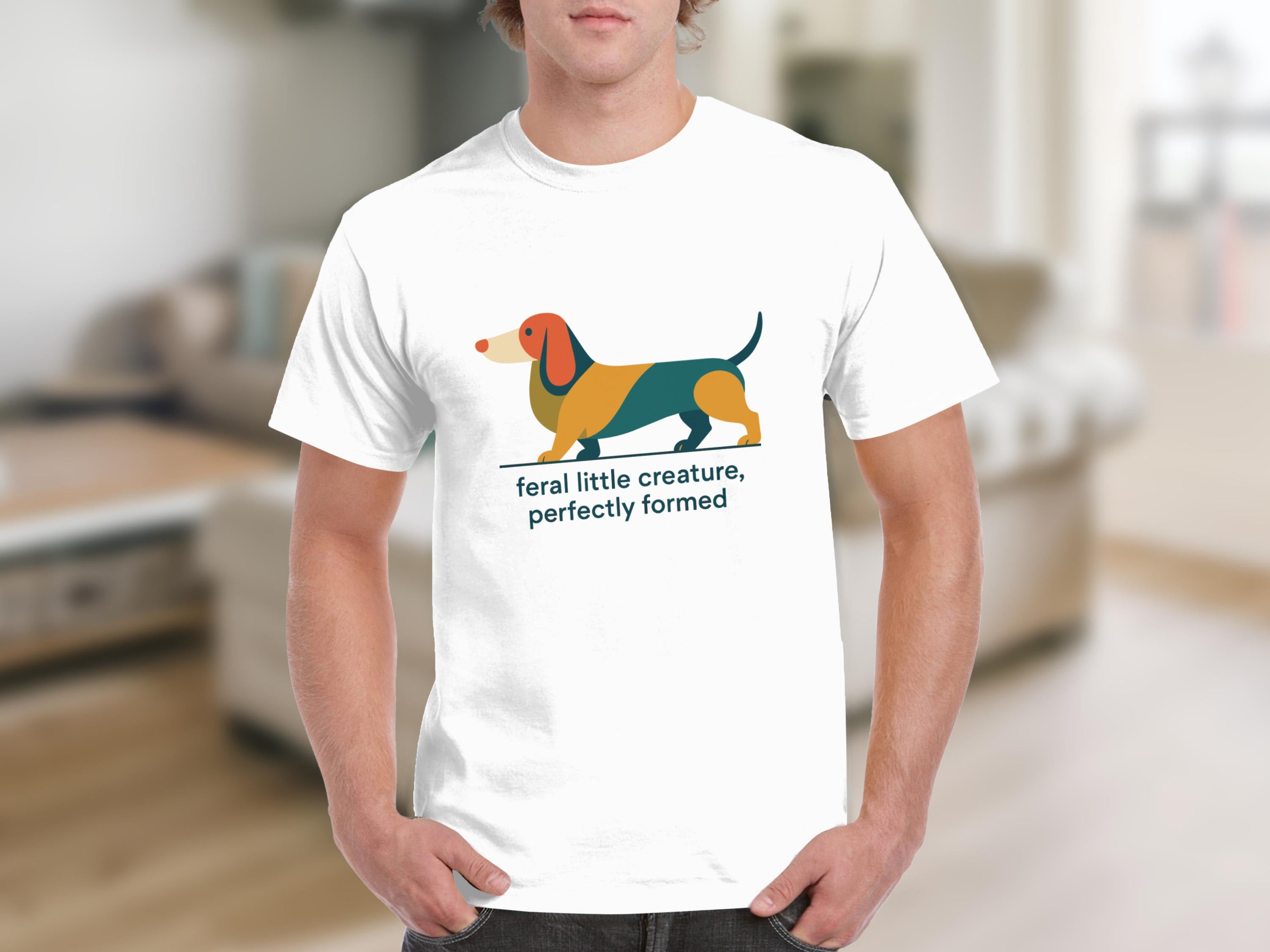 White t-shirt with graphic of colorful dachshund and text "feral little creature, perfectly formed".