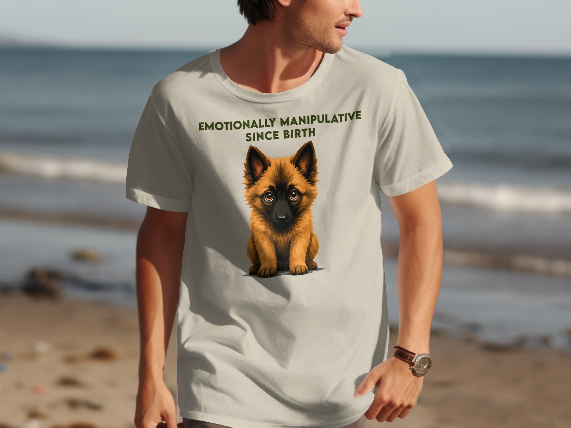 Light beige t-shirt with a cartoon dog and "EMOTIONALLY MANIPULATIVE SINCE BIRTH" text.