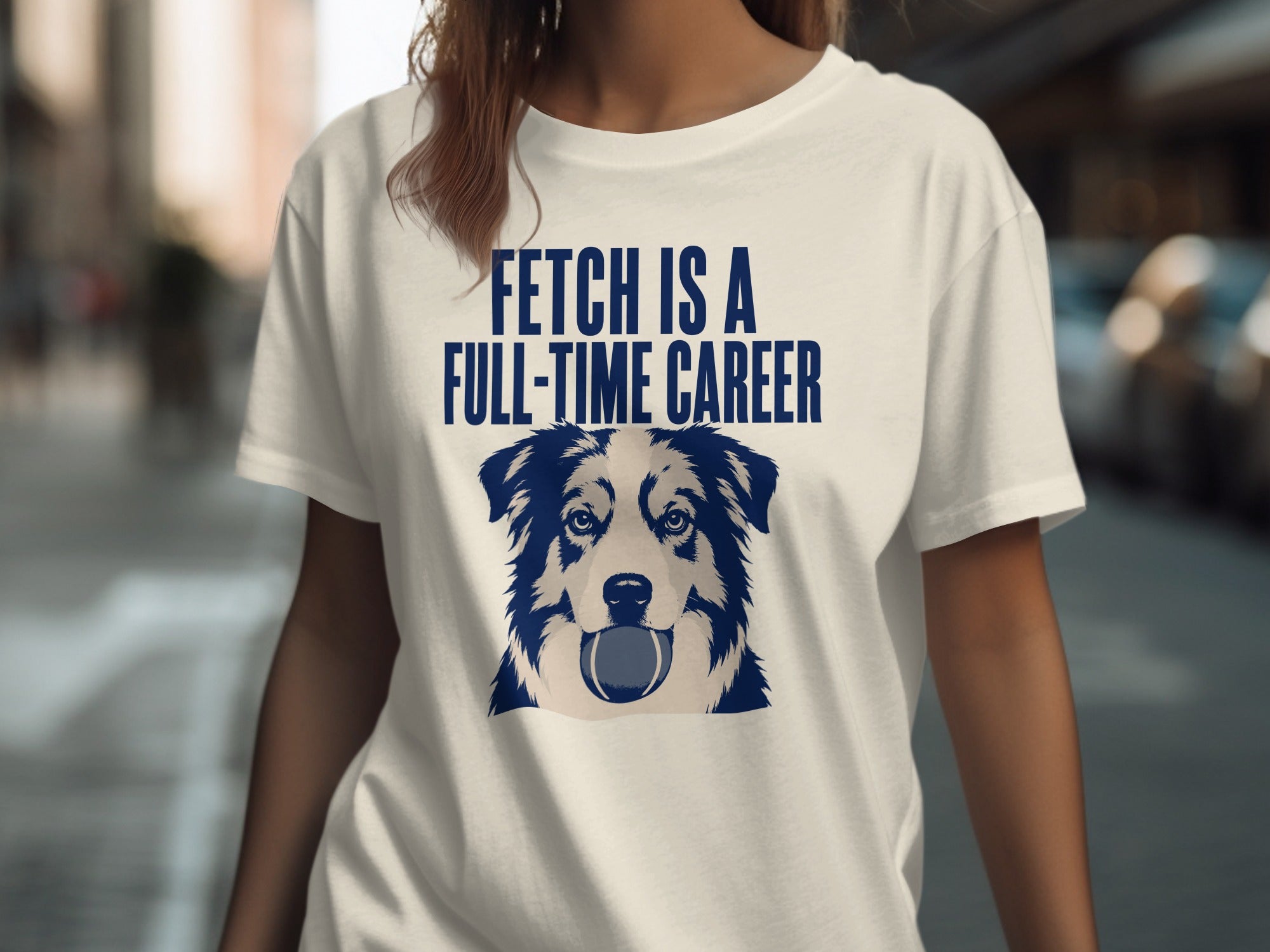Woman wearing a t-shirt with a dog's face and text "FETCH IS A FULL-TIME CAREER".
