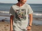 T-shirt graphic with a cartoon dog in a hat sniffing the ground with text "SNIFF FIRST ASK QUESTIONS LATER".