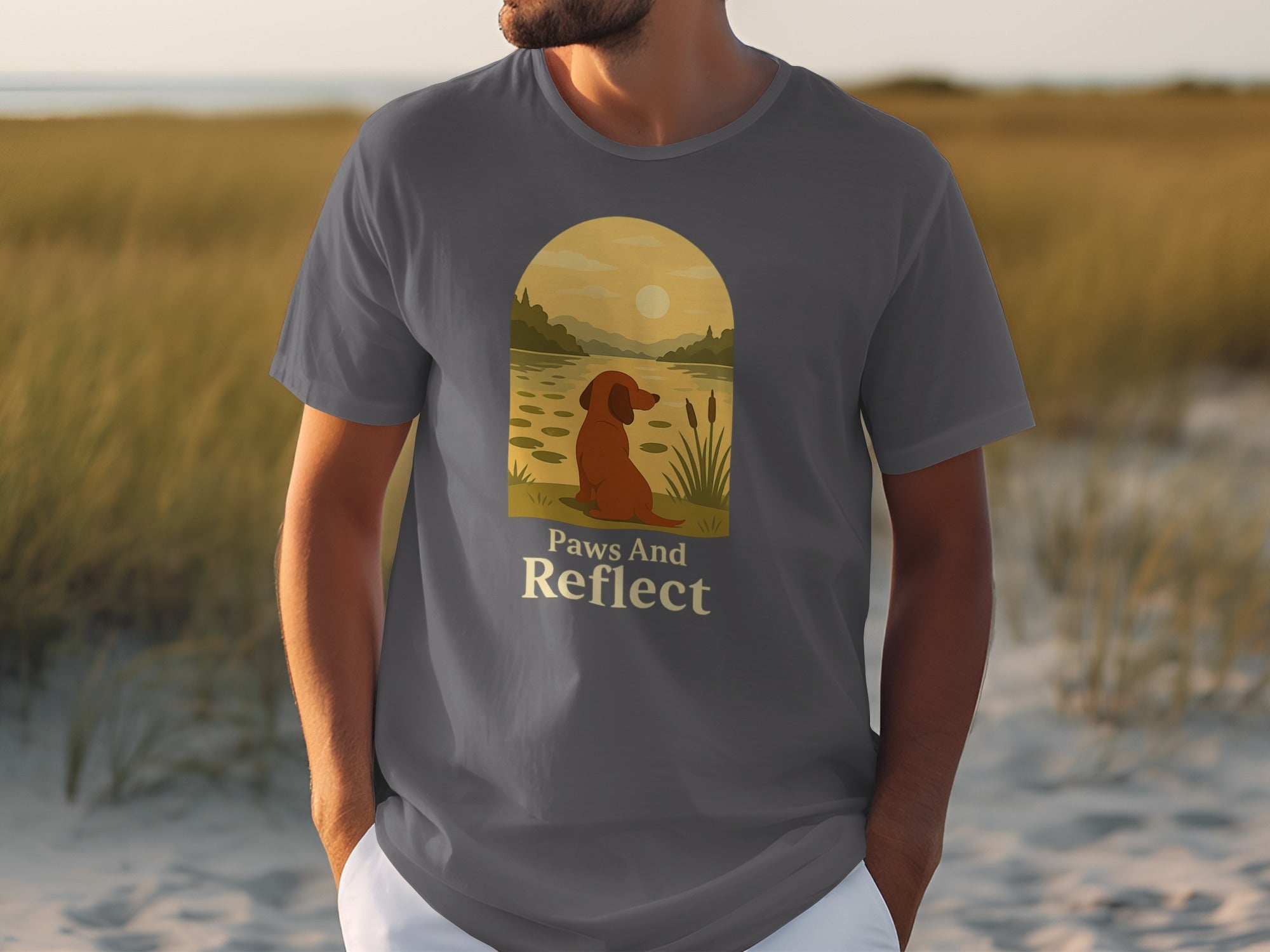 Gray t-shirt with a dog and sunset landscape and text "Paws And Reflect".