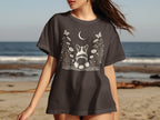 Dark grey t-shirt with a white graphic of a corgi amongst flowers and a moon.
