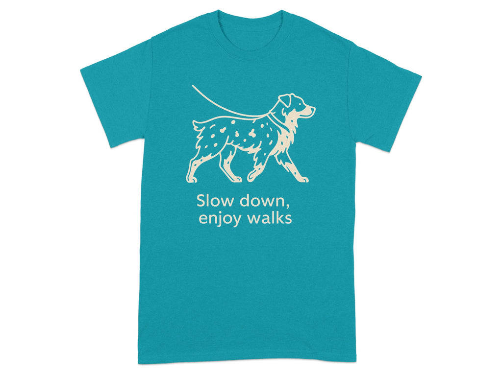 Teal t-shirt with a line drawing of a spotted dog on a leash and the text "Slow down, enjoy walks".