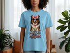Light blue t-shirt with a dog wearing sunglasses and a bow, text reads "First of all, I'm a delight."