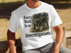 A schnauzer wearing a detective hat on a white t-shirt with "Every Walk Is an Investigation"