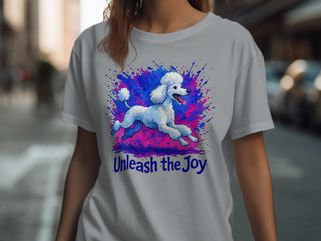 White poodle leaping through colorful splatters with "Unleash the Joy" text.