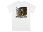 White t-shirt with dog wearing hat and text "Every Walk Is an Investigation".