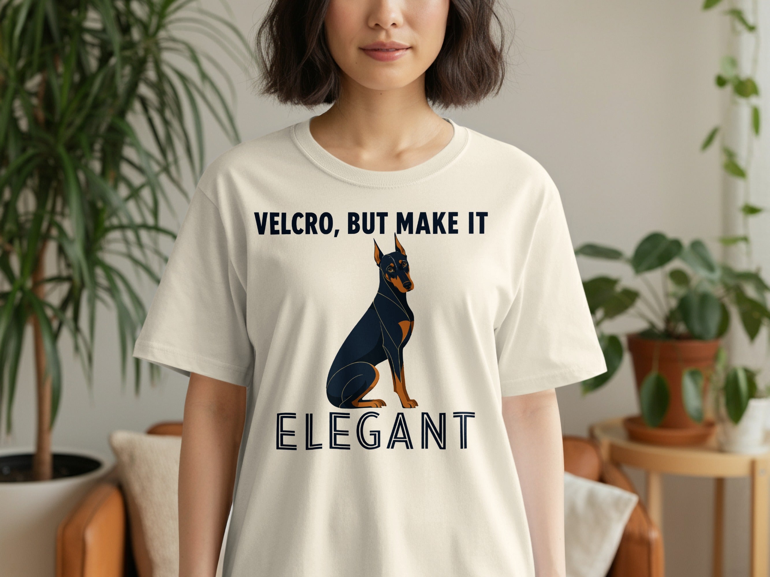 Cream t-shirt with a Doberman and text "VELCRO, BUT MAKE IT ELEGANT".