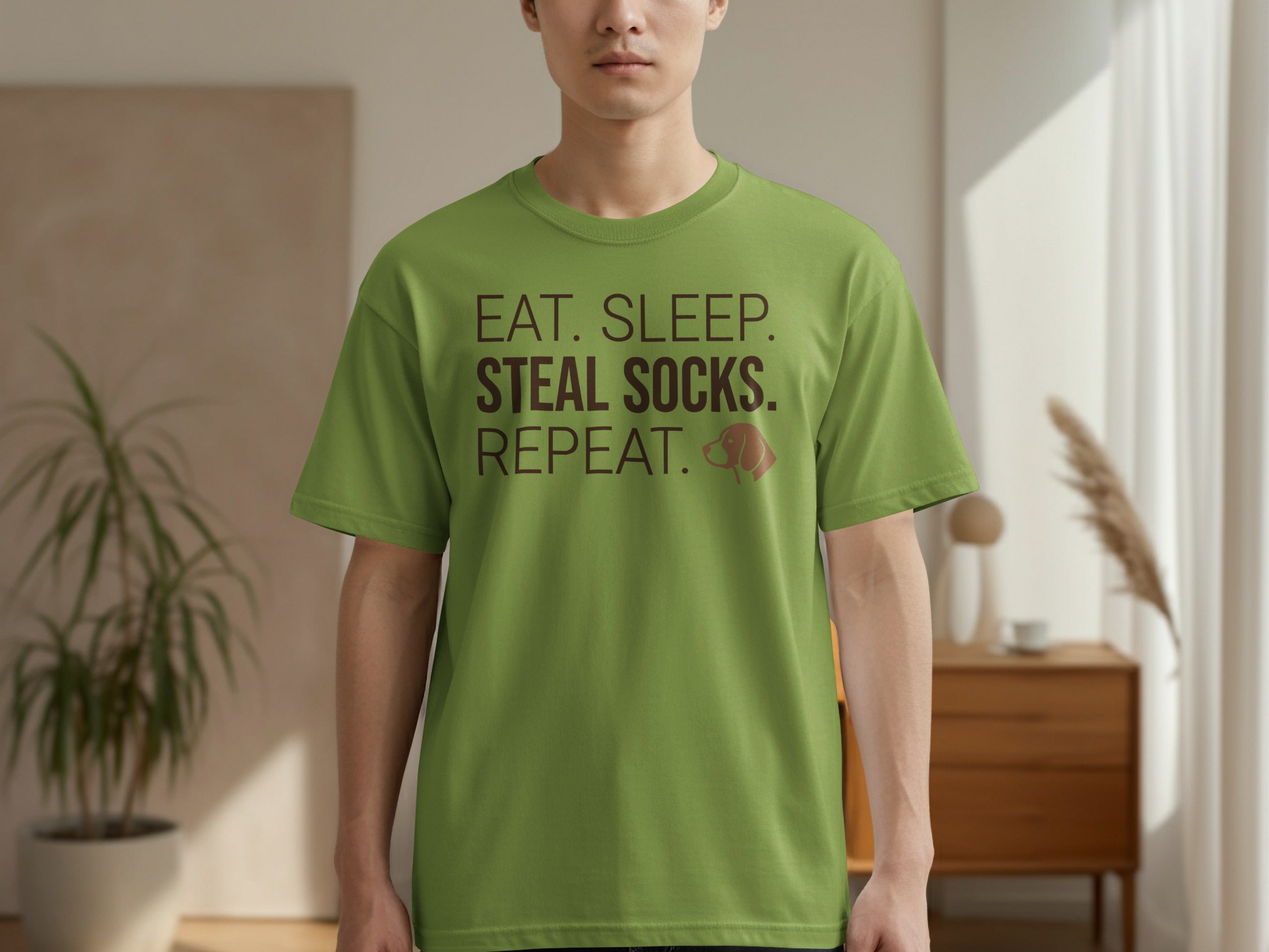 Green t-shirt with text "Eat. Sleep. Socks. Repeat." and a paw print.