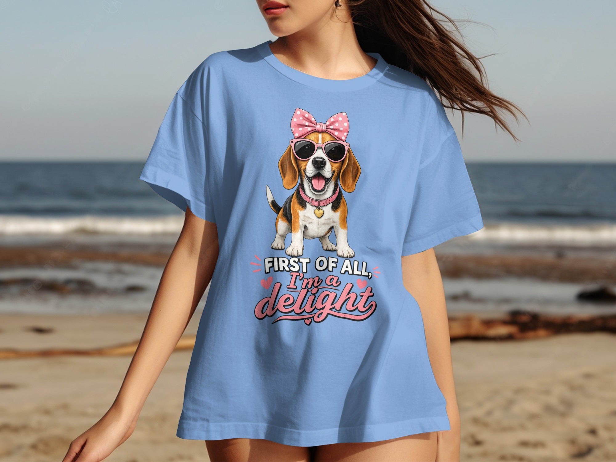 Light blue t-shirt with a beagle wearing sunglasses and a bow, saying "First of all, I'm a delight".