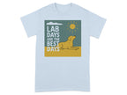 Light blue t-shirt with graphic of yellow lab lying under a sun and clouds with text "LAB DAYS ARE THE BEST DAYS".