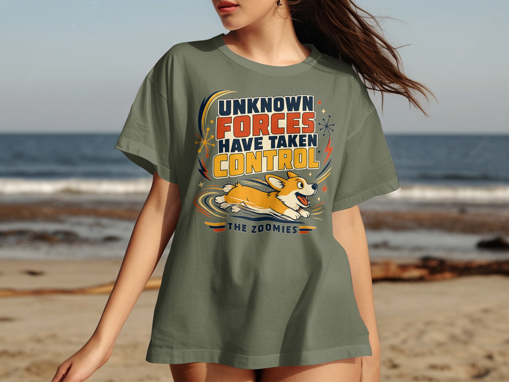 Green t-shirt with a corgi running and text "UNKNOWN FORCES HAVE TAKEN CONTROL THE ZOOMIES".