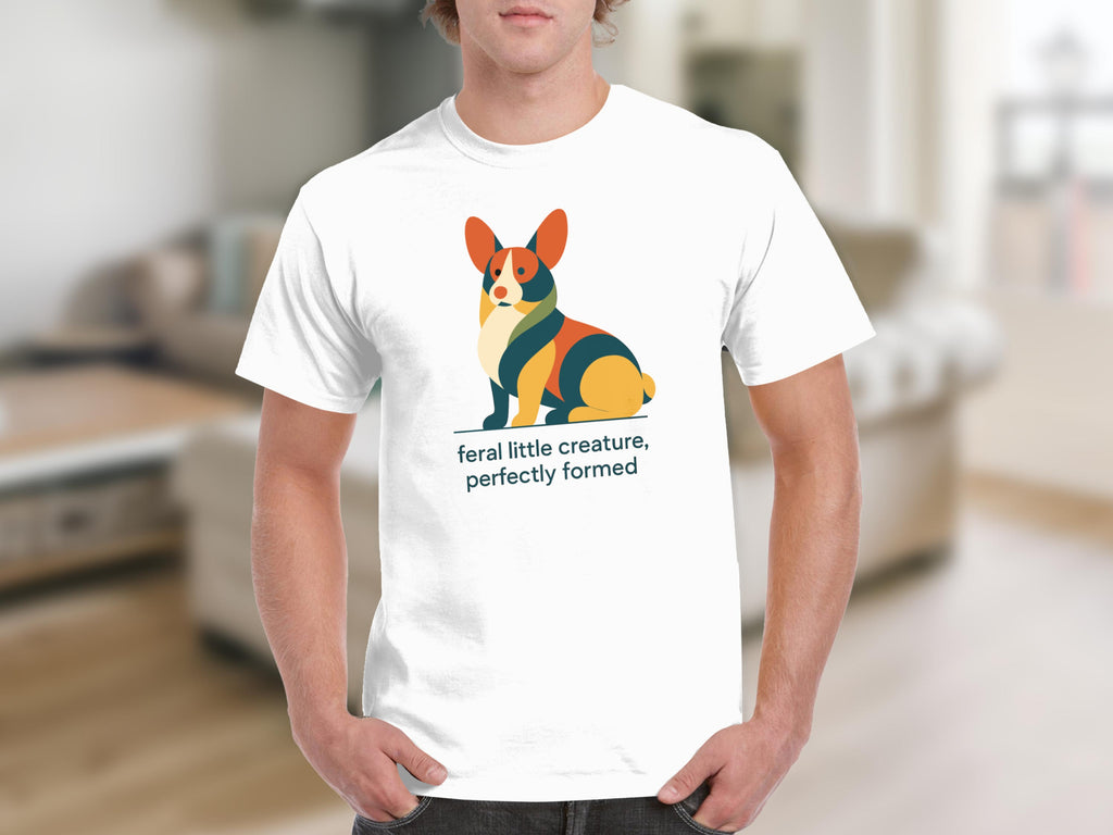 White t-shirt with stylized geometric corgi and text "feral little creature, perfectly formed".