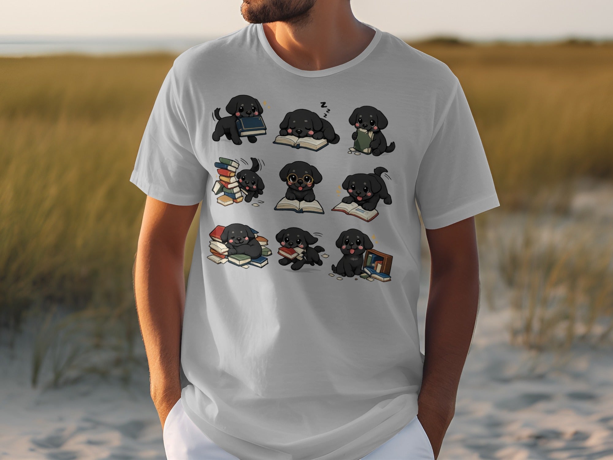 White t-shirt featuring nine cartoon black puppies interacting with books.