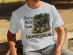 White t-shirt with text "Every Walk Is an Investigation" and a schnauzer wearing a deerstalker hat.