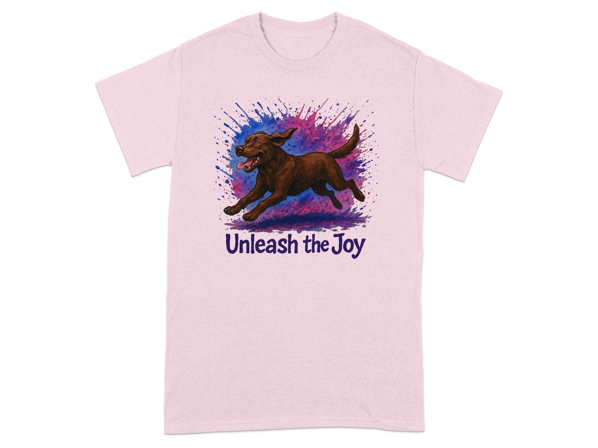 Pink t-shirt with a brown dog running through a colorful paint splatter and text "Unleash the Joy".
