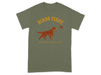 Green t-shirt with "BIRDS FIRST. EVERYTHING ELSE LATER." text and dog pointing at bird.