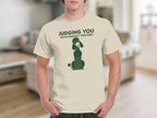 Cream t-shirt with green poodle graphic and "JUDGING YOU WITH PERFECT POSTURE" text.