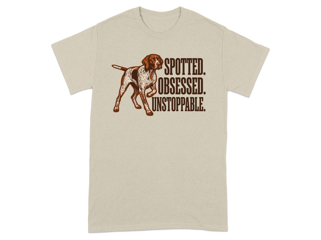Light beige t-shirt with brown dog and text "SPOTTED. OBSESSED. UNSTOPPABLE."