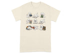 T-shirt with cream background featuring nine white poodles interacting with books.