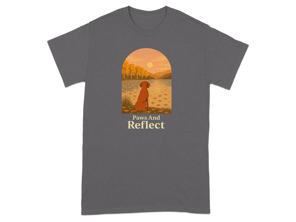 T-shirt with a dog looking at a sunset over a lake with text "Paws And Reflect".