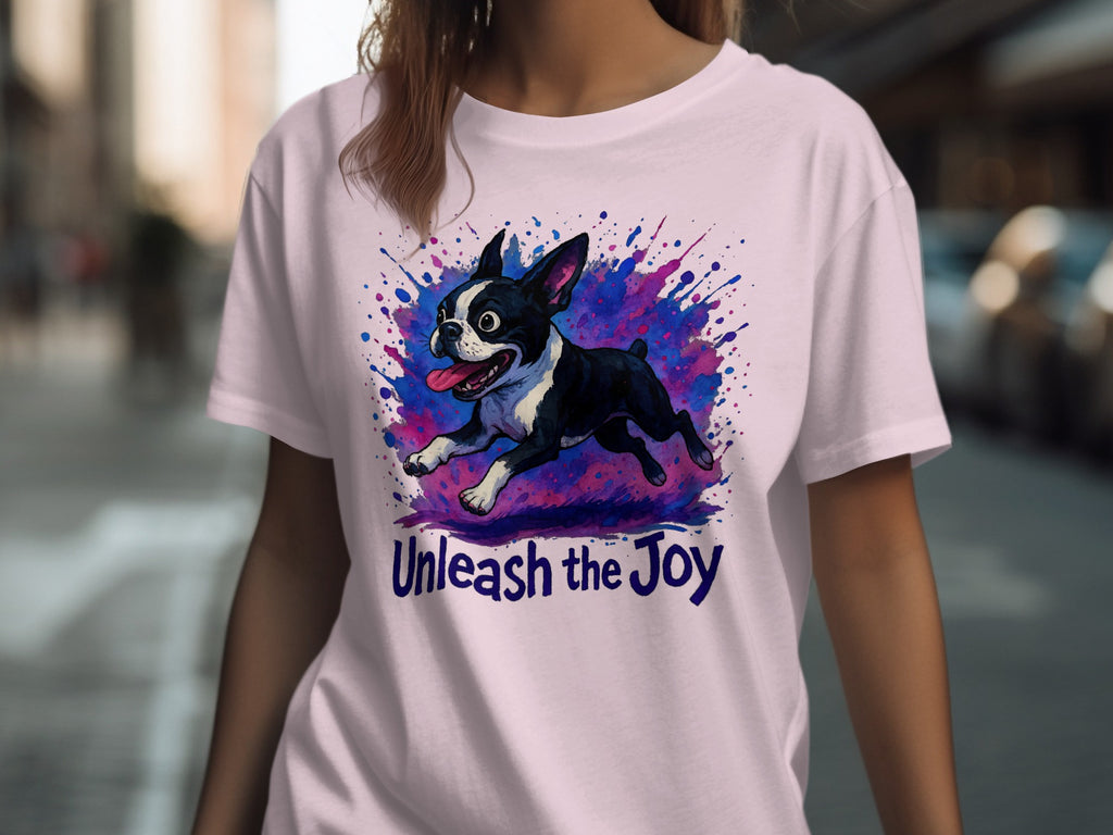 Boston Terrier illustration with "Unleash the Joy" text on a light pink t-shirt.