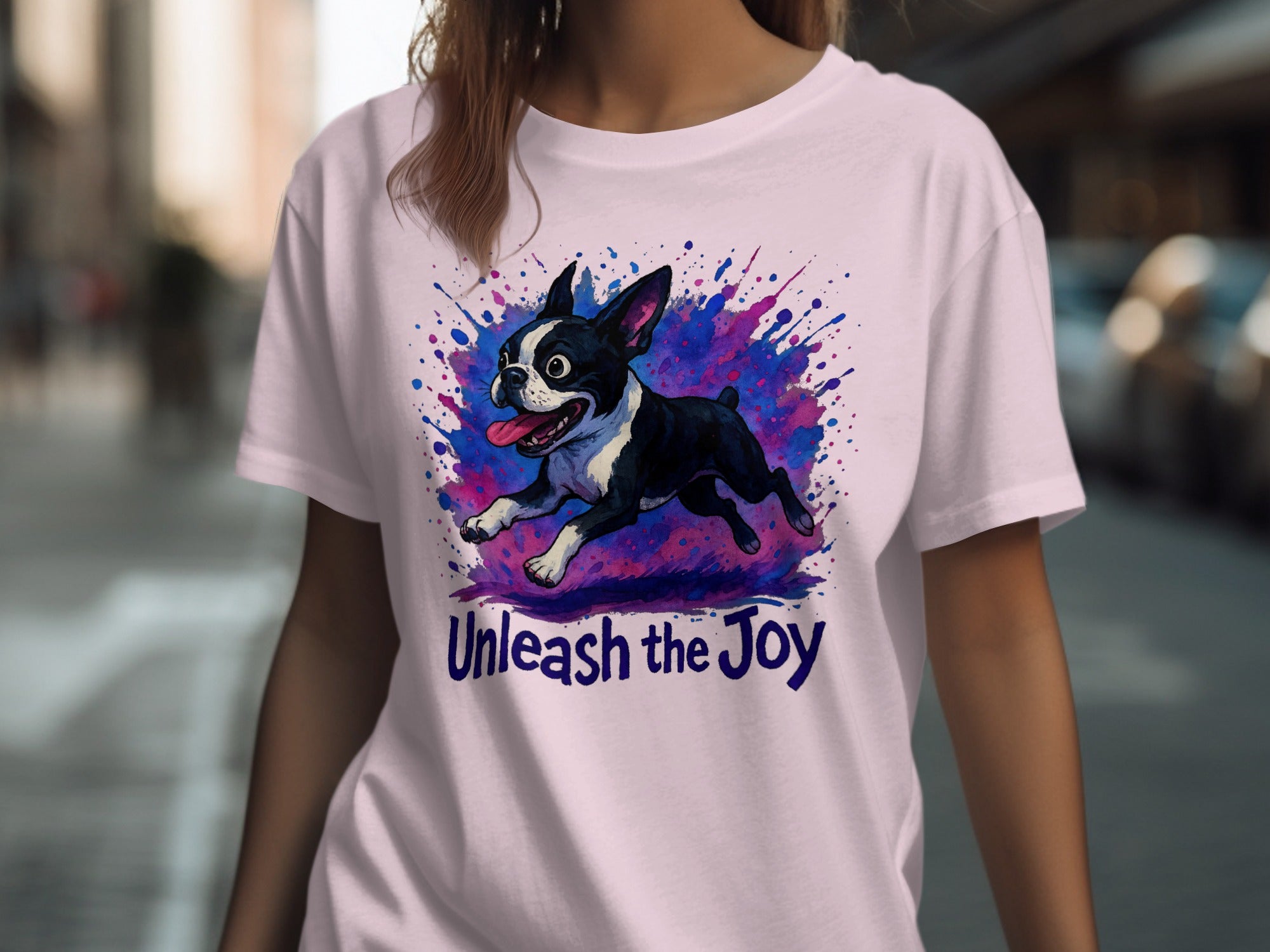 Boston Terrier illustration with "Unleash the Joy" text on a light pink t-shirt.