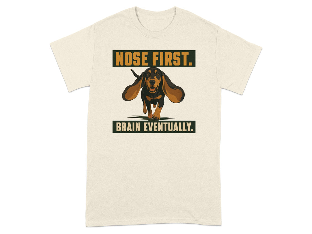 Cream t-shirt with graphic of a dachshund running with text "NOSE FIRST. BRAIN EVENTUALLY."