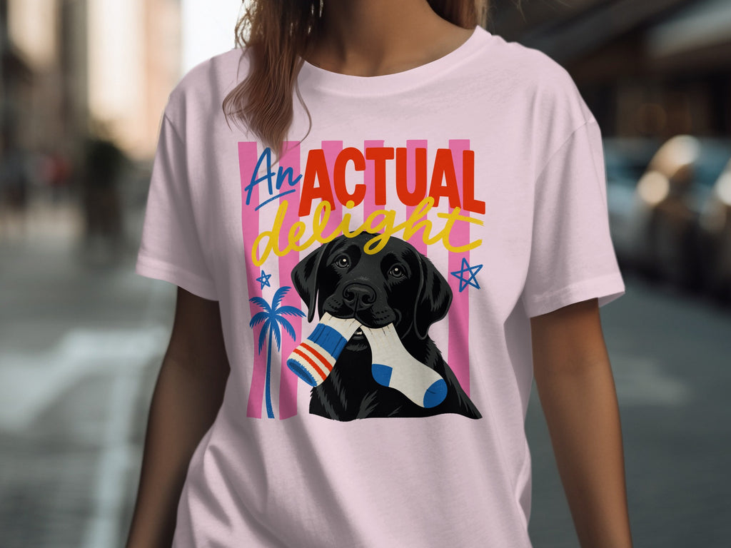 Pink t-shirt with black lab holding a striped sock in its mouth.