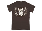 Brown t-shirt with a cute corgi wearing a bow, surrounded by flowers and text.