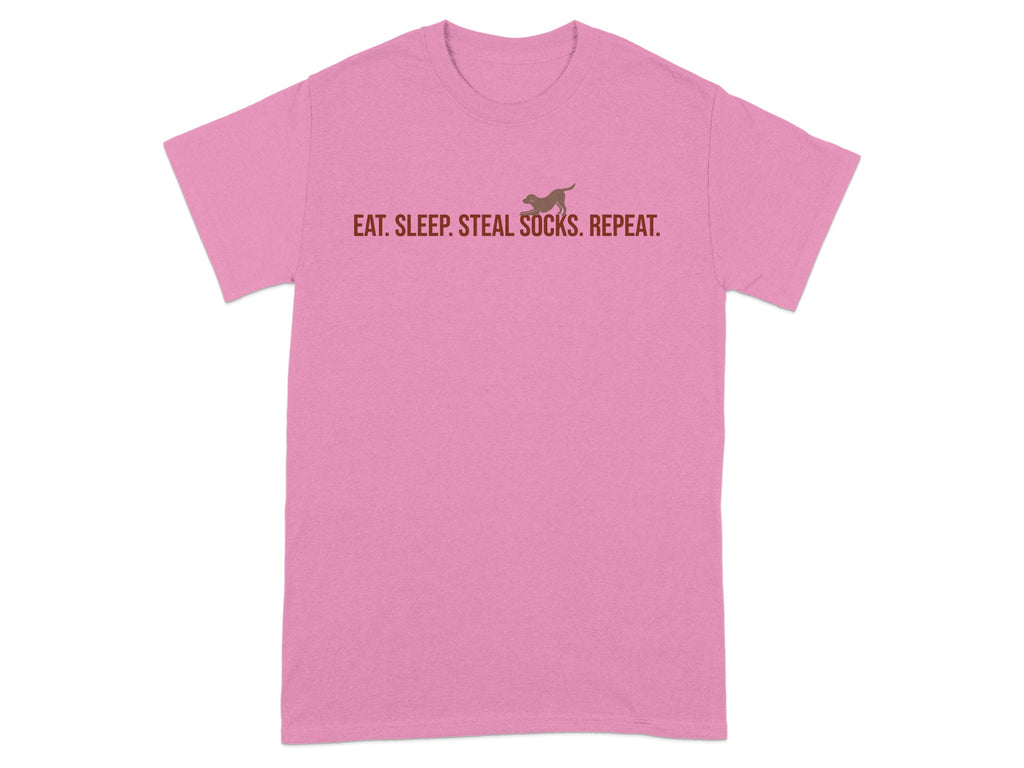 Pink t-shirt with brown text and a dog silhouette reading "EAT. SLEEP. STEAL SOCKS. REPEAT."