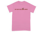 Pink t-shirt with brown text and a dog silhouette reading "EAT. SLEEP. STEAL SOCKS. REPEAT."