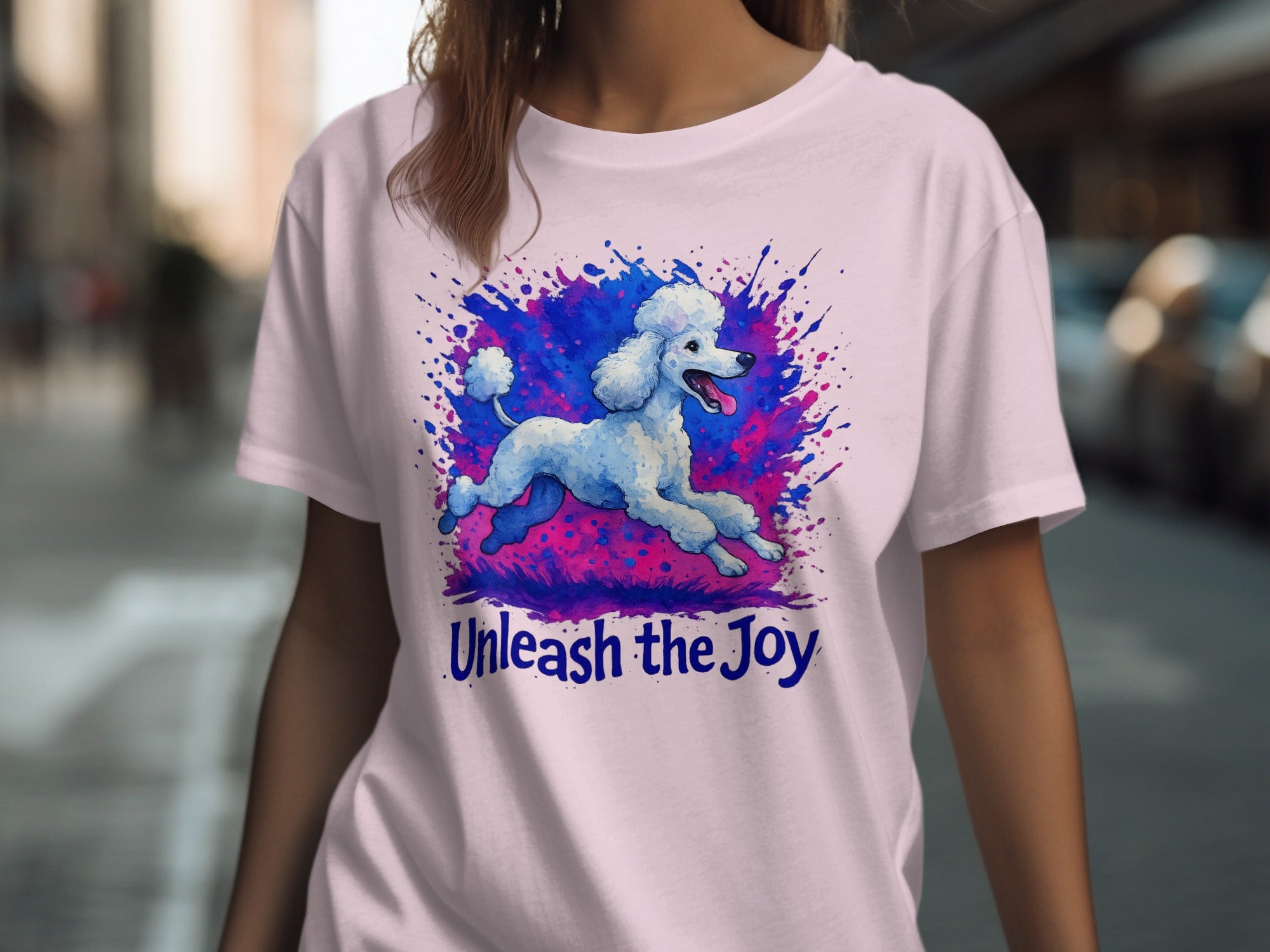 Pink t-shirt with watercolor poodle art and text "Unleash the Joy".