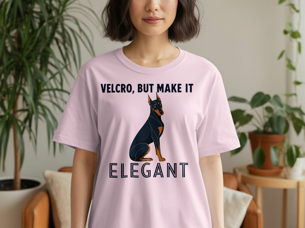 Pink t-shirt with a Doberman Pinscher and text "VELCRO, BUT MAKE IT ELEGANT".