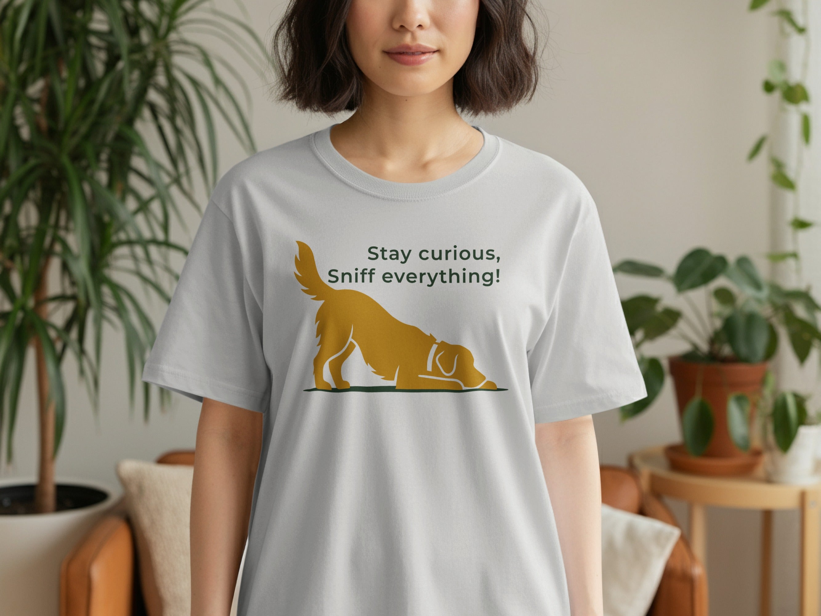 Gray t-shirt with golden dog silhouette and text "Stay curious, Sniff everything!"