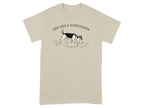 Beagle wearing detective hat on tan t-shirt, with paw prints.