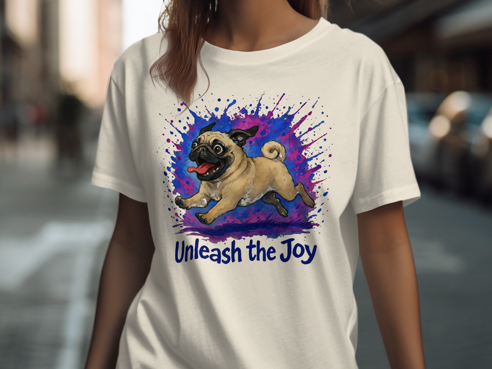 White t-shirt with a running pug graphic and the text "Unleash the Joy".