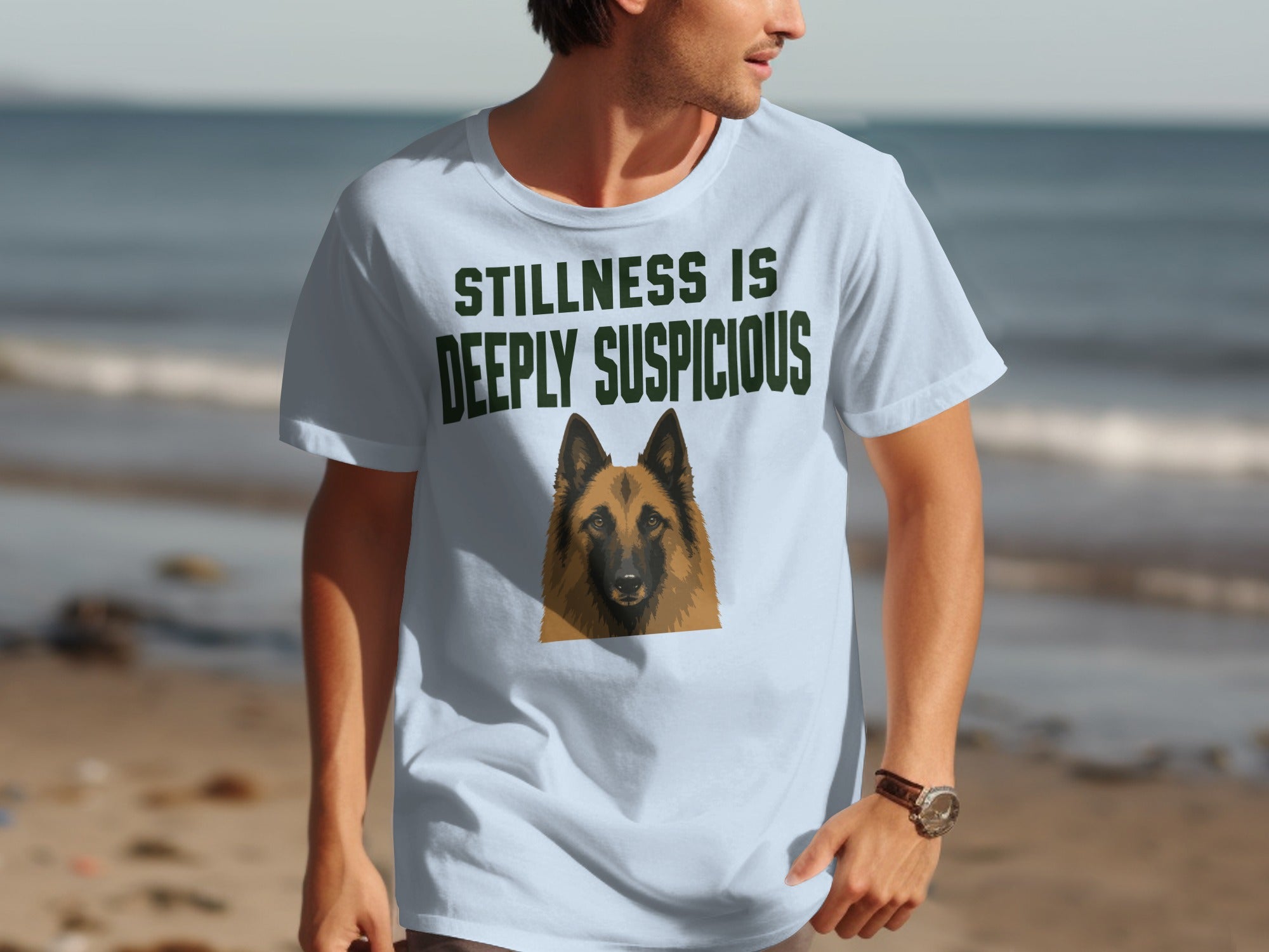 Light blue t-shirt with a German Shepherd portrait and "STILLNESS IS DEEPLY SUSPICIOUS" text.