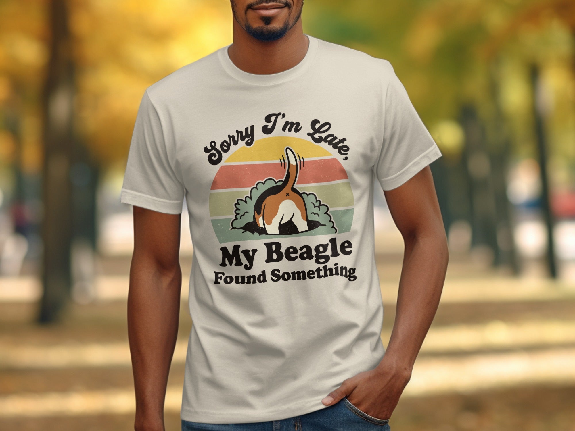 Cream t-shirt with beagle tail in dirt, "Sorry I'm Late, My Beagle Found Something" text.