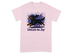 Pink t-shirt with a running black and tan dog and the text "Unleash the Joy".