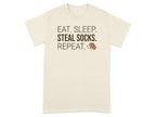 Cream t-shirt with "Eat. Sleep. Steal Socks. Repeat." text and a dog illustration.