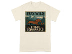 Cream t-shirt with "STAY WILD CHASE SQUIRRELS" text and dog chasing squirrel graphic.